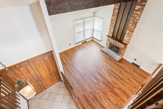7713 E Jamison Dr, Centennial, CO 80112 - unfurnished living room with a brick fireplace and light tile patterned floors