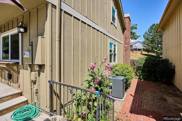 7713 E Jamison Dr, Centennial, CO 80112 - view of home's exterior with a central AC unit and board and batten siding