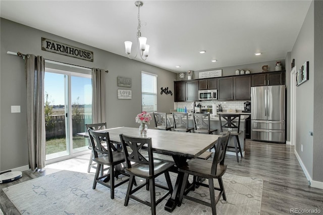975 Alta St, Lochbuie, CO 80603 - dining room featuring a chandelier, baseboards, recessed lighting, and light wood-style flooring