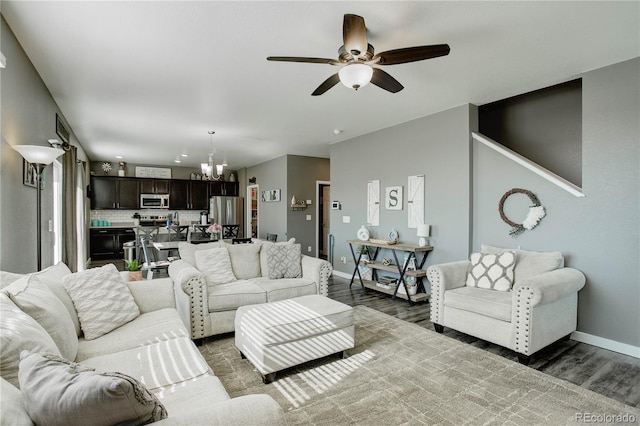 975 Alta St, Lochbuie, CO 80603 - living room featuring a chandelier, wood finished floors, baseboards, and a ceiling fan