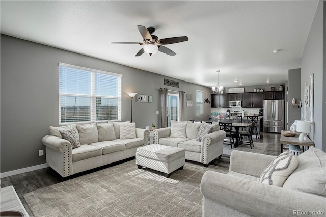 975 Alta St, Lochbuie, CO 80603 - living area with ceiling fan, wood finished floors, and baseboards