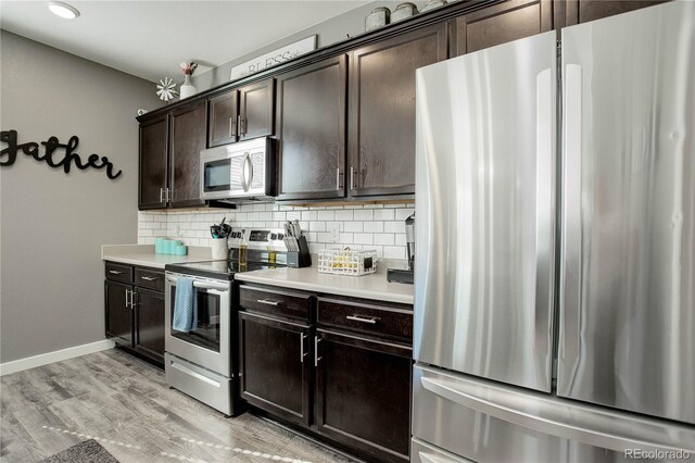 975 Alta St, Lochbuie, CO 80603 - kitchen with stainless steel appliances, tasteful backsplash, light countertops, dark brown cabinets, and recessed lighting