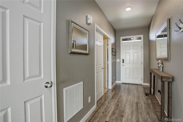 975 Alta St, Lochbuie, CO 80603 - entryway featuring wood finished floors, baseboards, and a textured wall