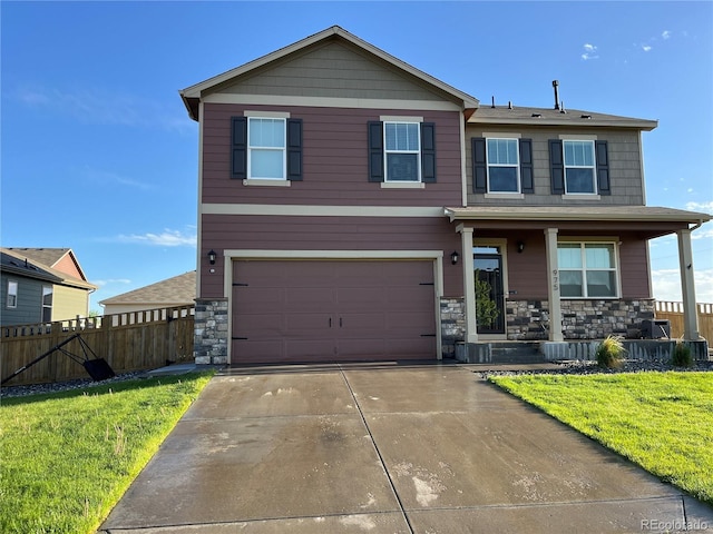 975 Alta St, Lochbuie, CO 80603 - view of front of home with covered porch, an attached garage, stone siding, and driveway