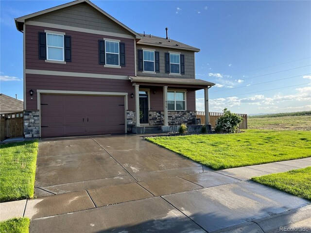 975 Alta St, Lochbuie, CO 80603 - view of front of property featuring covered porch, stone siding, a front lawn, and concrete driveway