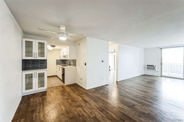 interior space featuring ceiling fan, dark wood-style flooring, and a sink