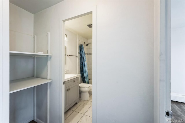 bathroom featuring toilet, shower / tub combo, visible vents, and vanity