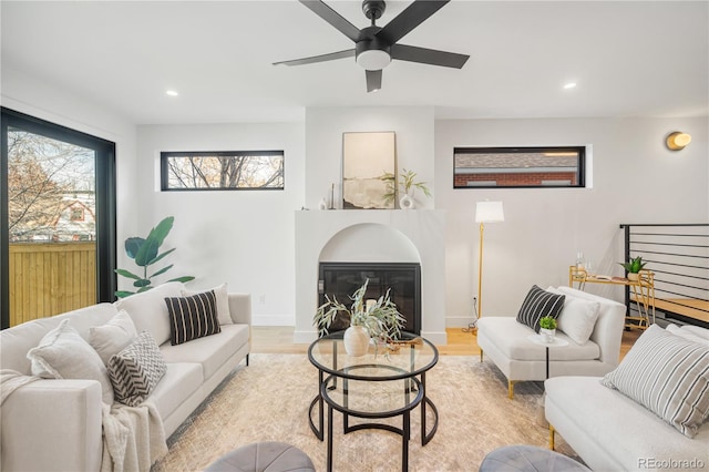 living room with ceiling fan and light hardwood / wood-style flooring