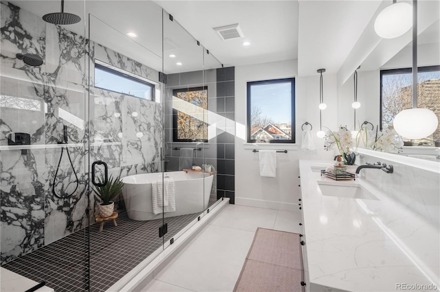 bathroom with shower with separate bathtub, vanity, tile patterned floors, and tile walls