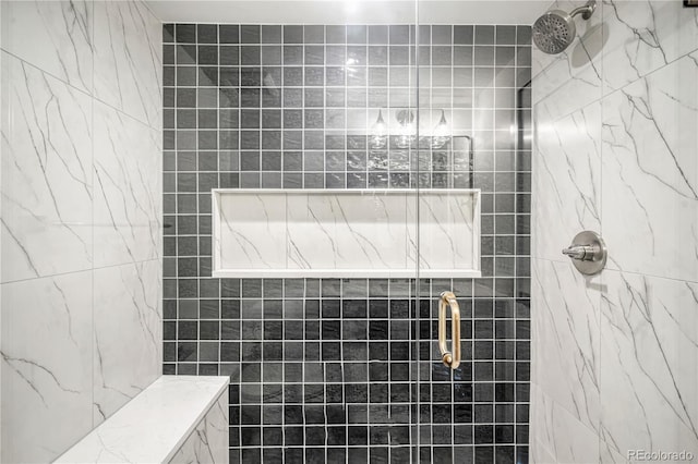 bathroom with a tile shower