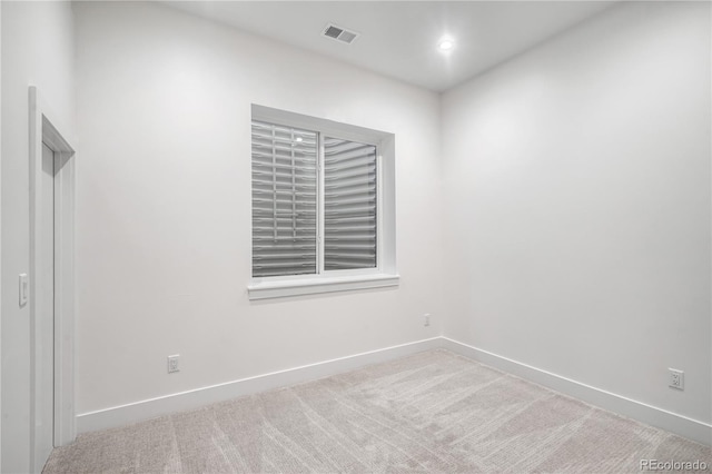 unfurnished room with light colored carpet