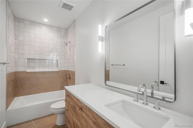 full bathroom with tile patterned flooring, vanity, toilet, and tiled shower / bath combo