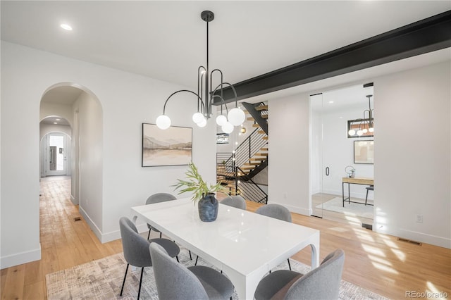 dining room featuring light hardwood / wood-style floors and a chandelier