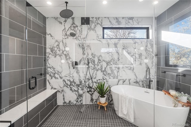 bathroom featuring tile patterned flooring, separate shower and tub, and tile walls