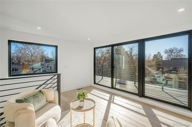 living room featuring plenty of natural light and light wood-type flooring