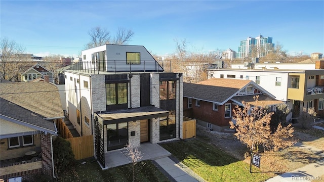 view of front of home with a patio area and a balcony