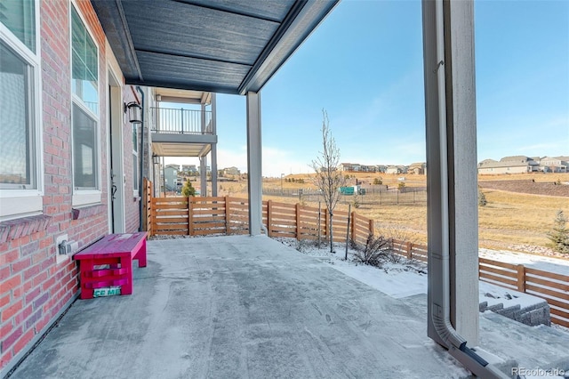 view of patio featuring a balcony and a rural view