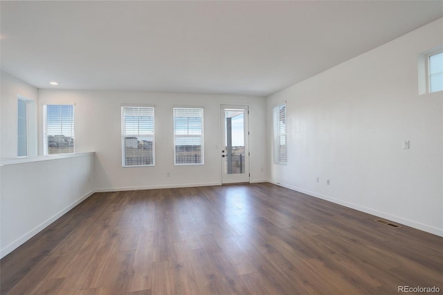 spare room with dark hardwood / wood-style floors