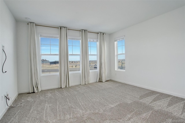 carpeted spare room with a water view