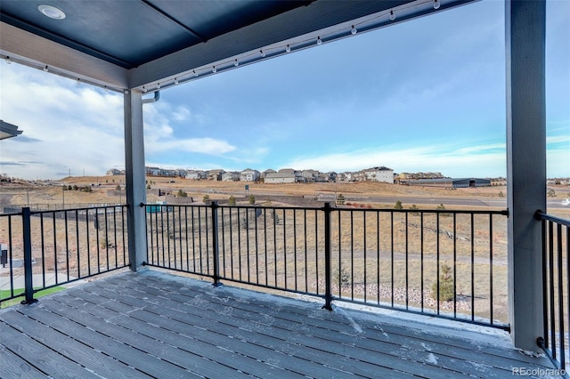 wooden deck with a rural view