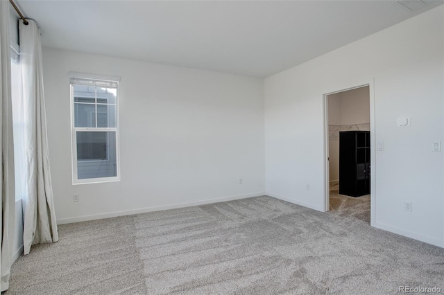 unfurnished room featuring light carpet