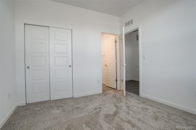 unfurnished bedroom with carpet floors and a closet