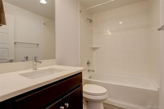 full bathroom with tiled shower / bath combo, vanity, and toilet