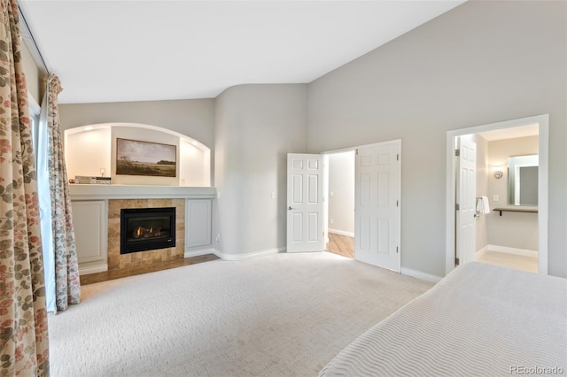 carpeted living room featuring a fireplace and lofted ceiling