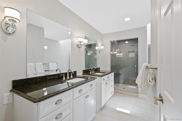 bathroom with tile flooring, an enclosed shower, and vanity