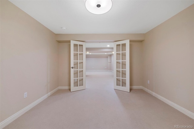 carpeted empty room featuring french doors