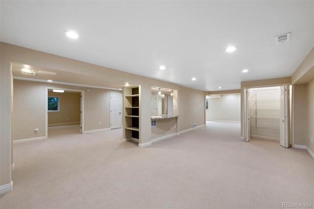 basement featuring light carpet