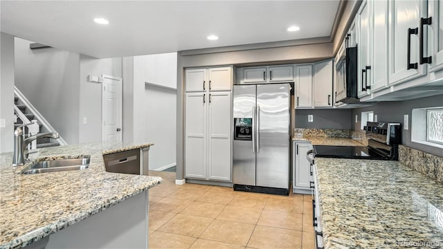 4458 Lyndenwood Pt, Highlands Ranch, CO 80130 - kitchen featuring appliances with stainless steel finishes, recessed lighting, light stone countertops, and light tile patterned flooring