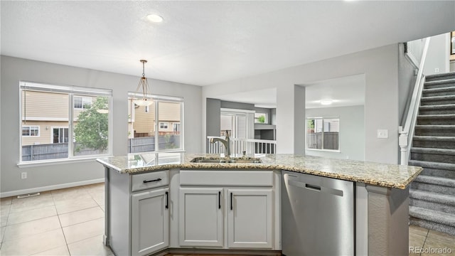 4458 Lyndenwood Pt, Highlands Ranch, CO 80130 - kitchen featuring dishwasher, light tile patterned floors, and plenty of natural light