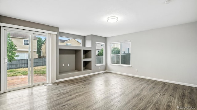 4458 Lyndenwood Pt, Highlands Ranch, CO 80130 - spare room featuring wood finished floors and baseboards