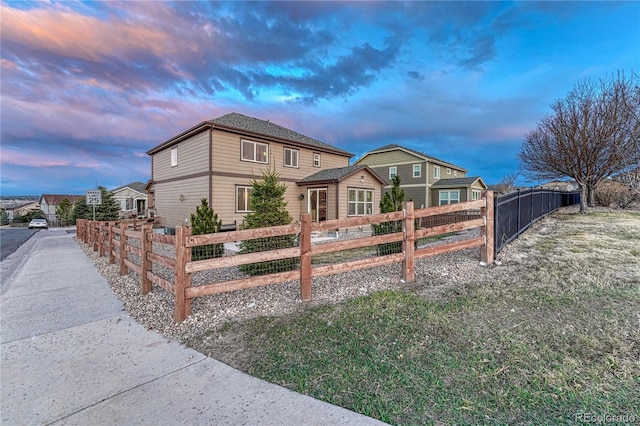 view of front facade featuring fence private yard