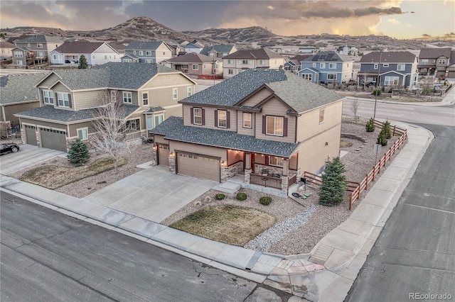 aerial view at dusk with a mountain view and a residential view