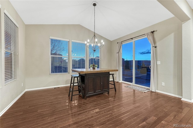dining area featuring lofted ceiling, baseboards, a notable chandelier, and dark wood finished floors