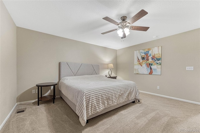 bedroom featuring carpet floors, visible vents, a ceiling fan, and baseboards