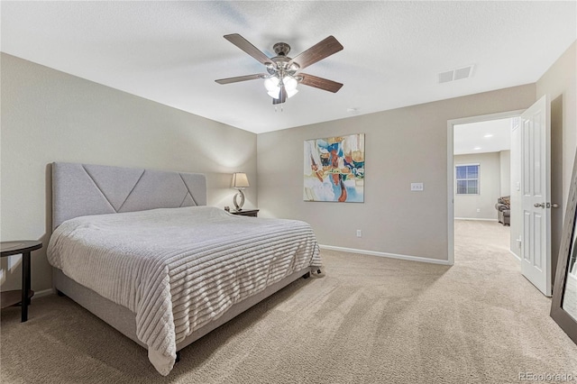 bedroom with light carpet, baseboards, visible vents, and ceiling fan