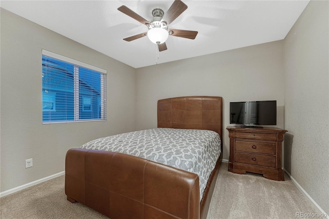 carpeted bedroom with baseboards and ceiling fan