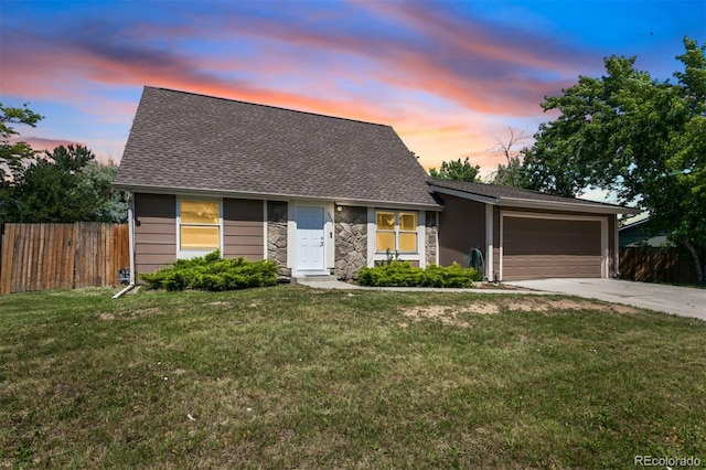 6579 Ingalls St, Arvada, CO 80003 - view of front facade featuring concrete driveway, an attached garage, stone siding, and a shingled roof