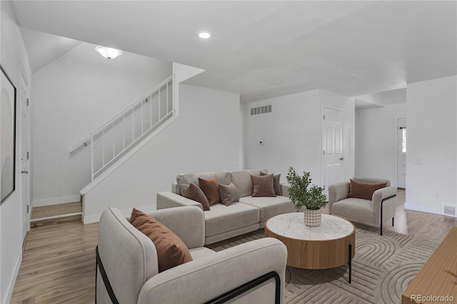 6579 Ingalls St, Arvada, CO 80003 - living area featuring stairway, light wood finished floors, and recessed lighting