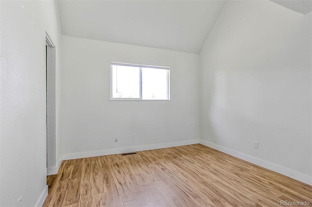 6579 Ingalls St, Arvada, CO 80003 - spare room featuring vaulted ceiling and light wood-style flooring
