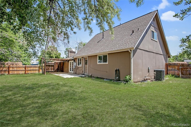 6579 Ingalls St, Arvada, CO 80003 - back of house with a shingled roof, a fenced backyard, a patio, and a chimney
