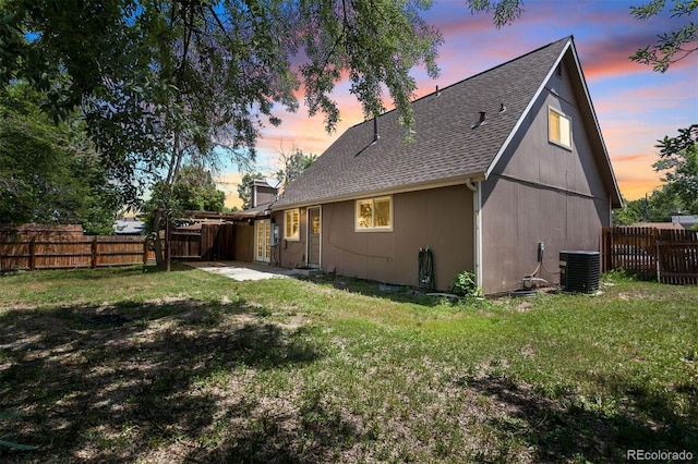 6579 Ingalls St, Arvada, CO 80003 - back of property at dusk with a shingled roof, a fenced backyard, and a patio area