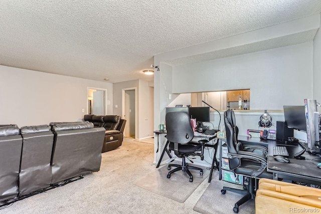 carpeted office featuring a textured ceiling