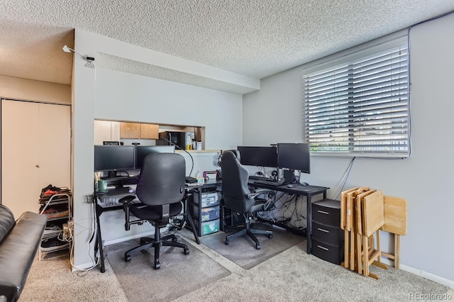 office space with light carpet and a textured ceiling