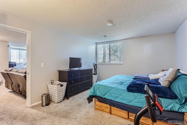 carpeted bedroom featuring a textured ceiling