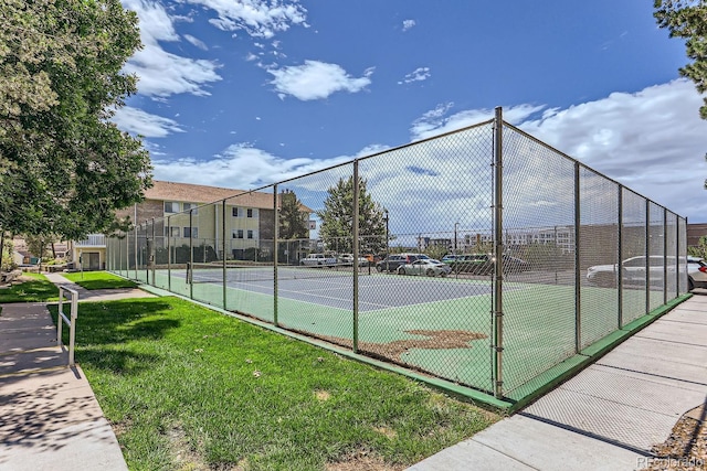 view of sport court with a yard