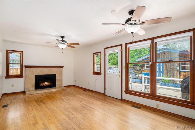 3272 S Joplin Ct, Aurora, CO 80013 - unfurnished living room with a ceiling fan, healthy amount of natural light, light wood finished floors, and a fireplace
